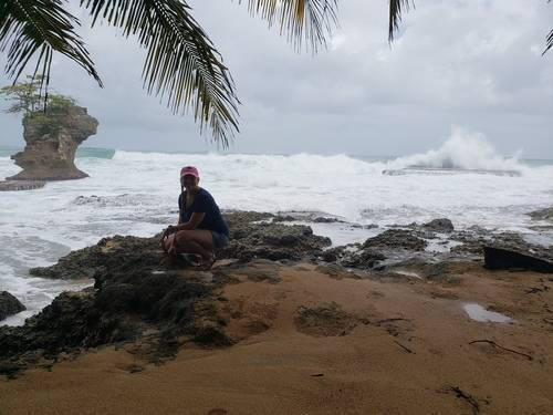 Alumna Kelli Dykstra Darcia on a rocky beach